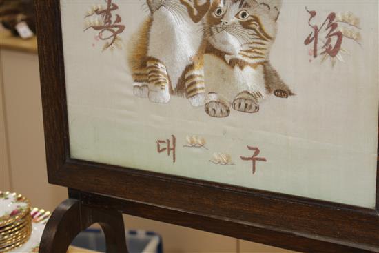 An early 20th century Japanese silkwork panel of two kittens, mounted as an oak firescreen, panel 40 x 43cm and